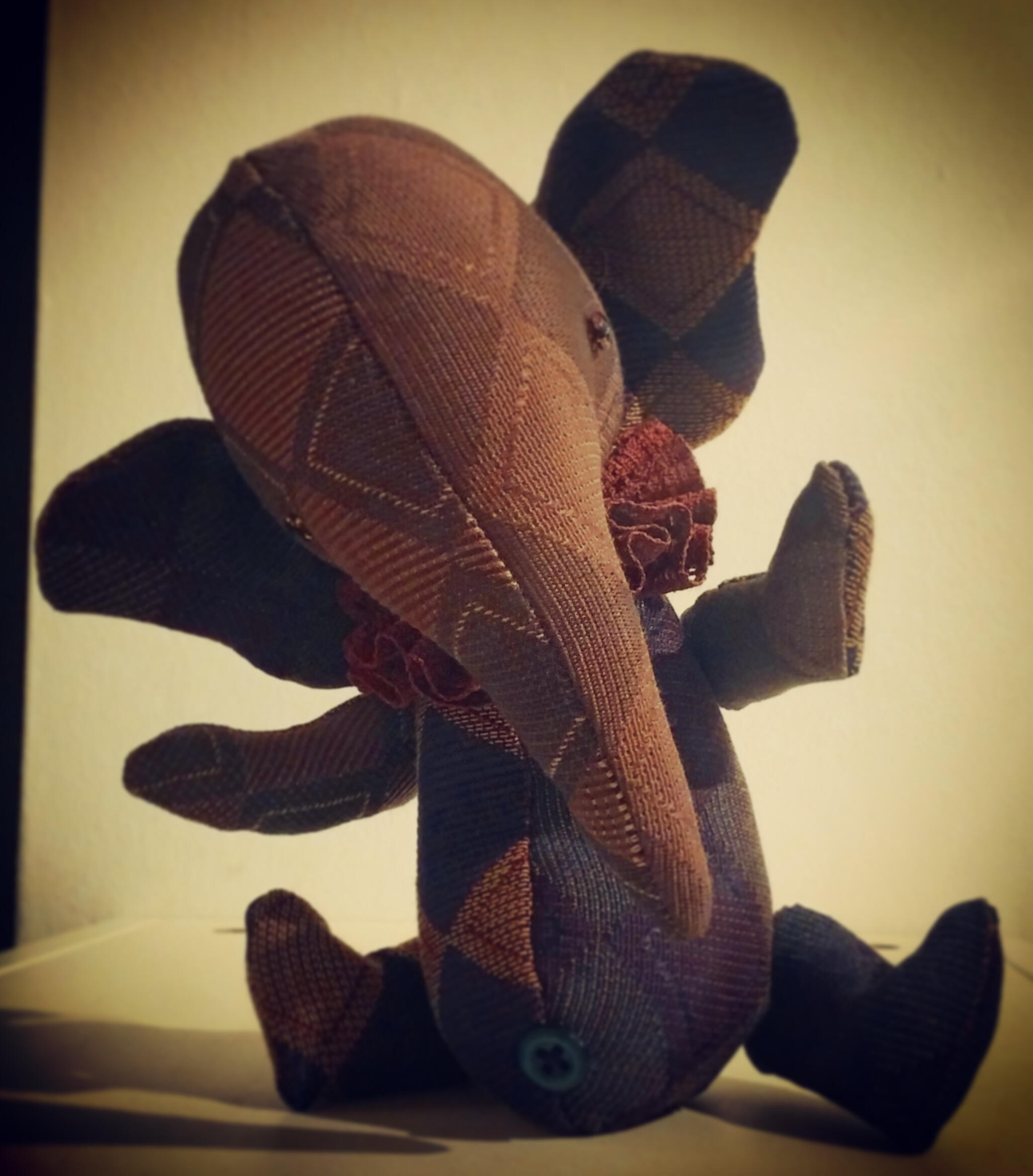 Elle Phuntte A whimsical stuffed elephant doll made out of vintage harlequin fabric in shades of purple with a ruffled collar